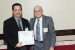 Dr. Nagib Callaos, General Chair, giving Dr. Houman Sadri the best paper award certificate of the session "Interdisciplinary Education / Education in Science, Technology, Engineering and Mathematics". The title of the awarded paper is "Using an Interdisciplinary Course to Teach Intercultural Communication: Helping Students and Faculty Bridge Disciplinary Divides."